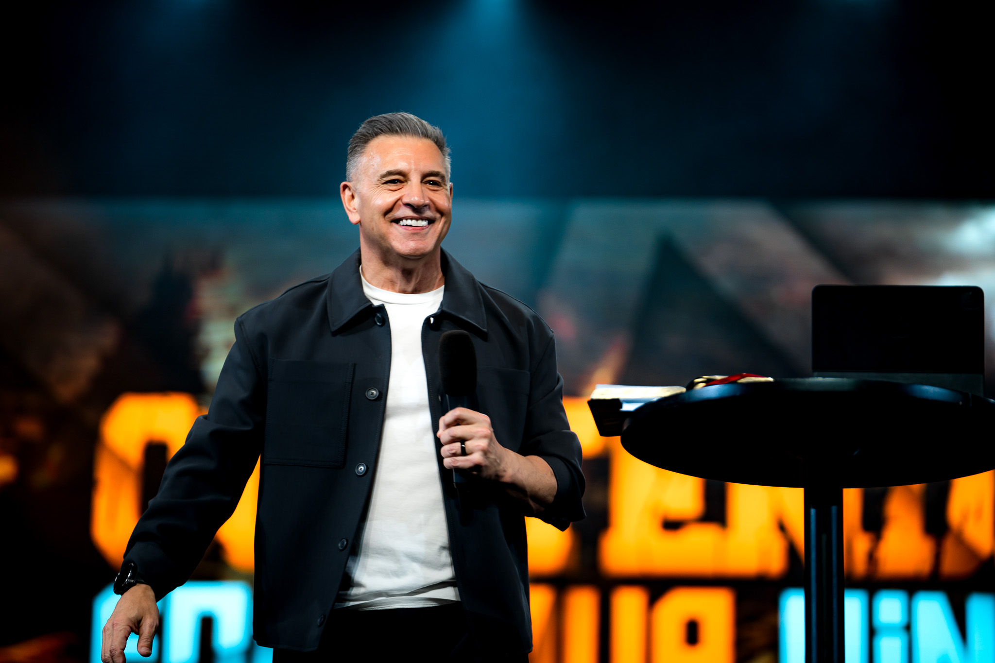 John Torrens speaking on stage